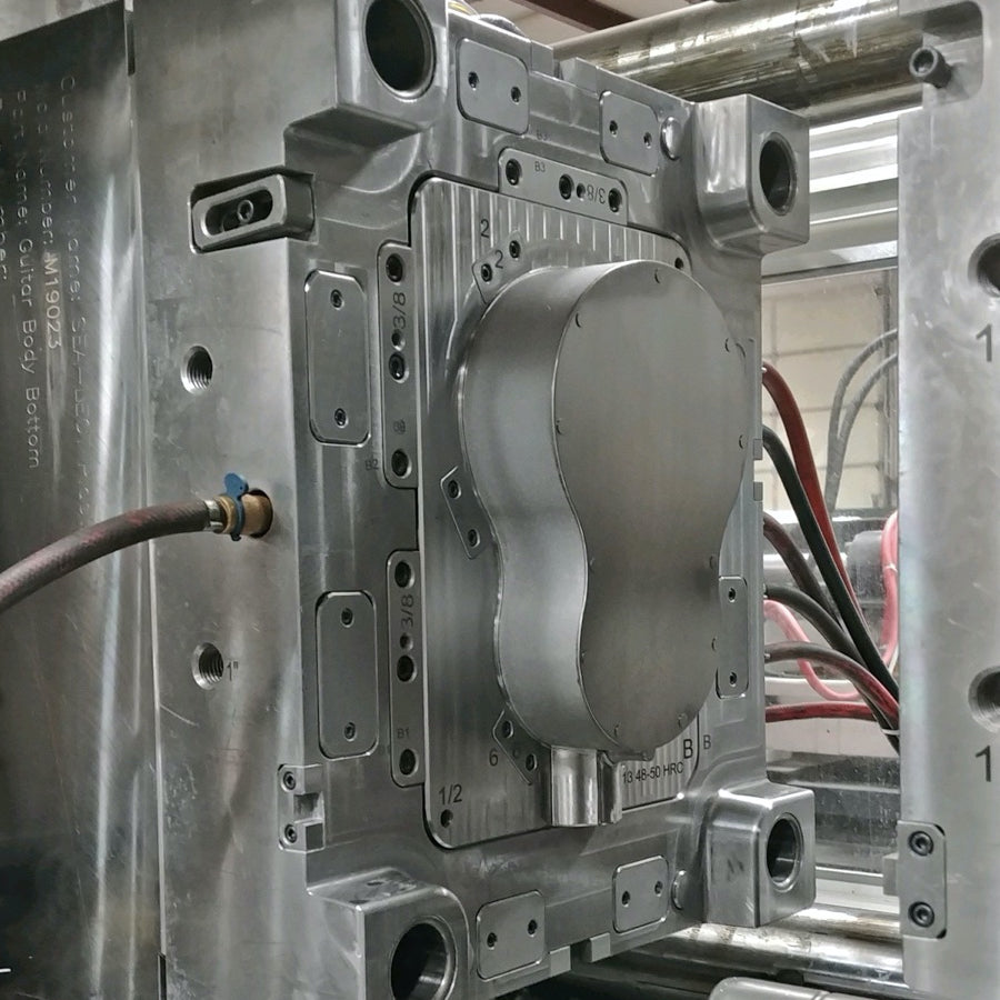 Outdoor Guitar™ injection molding under high heat and pressure.